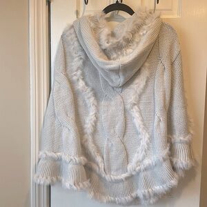 Soft cream colored thick knit hooded cape with accented rabbit fur trimming